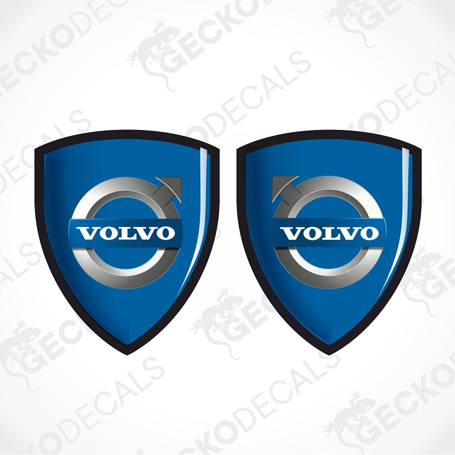 Two blue Volvo shield-shaped decals with the Volvo logo in the center, shown on a light gray background with faint watermark text.