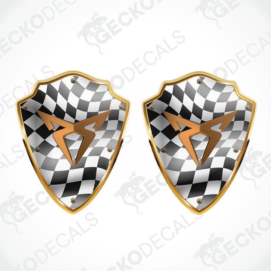 Two matching shield-shaped decals with a black and white checkered pattern, a metallic gold border, and a gold lightning bolt emblem in the center, shown on a white background with faint watermark text.