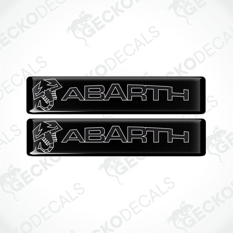 Two black vinyl stickers with the word 'ABARTH' written in white. Each sticker has a white graphic of a bird above the text.