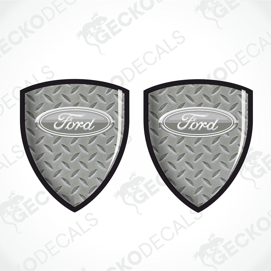 Two Ford shield-shaped metal diamond plate decals on a white background with a faint watermark pattern.