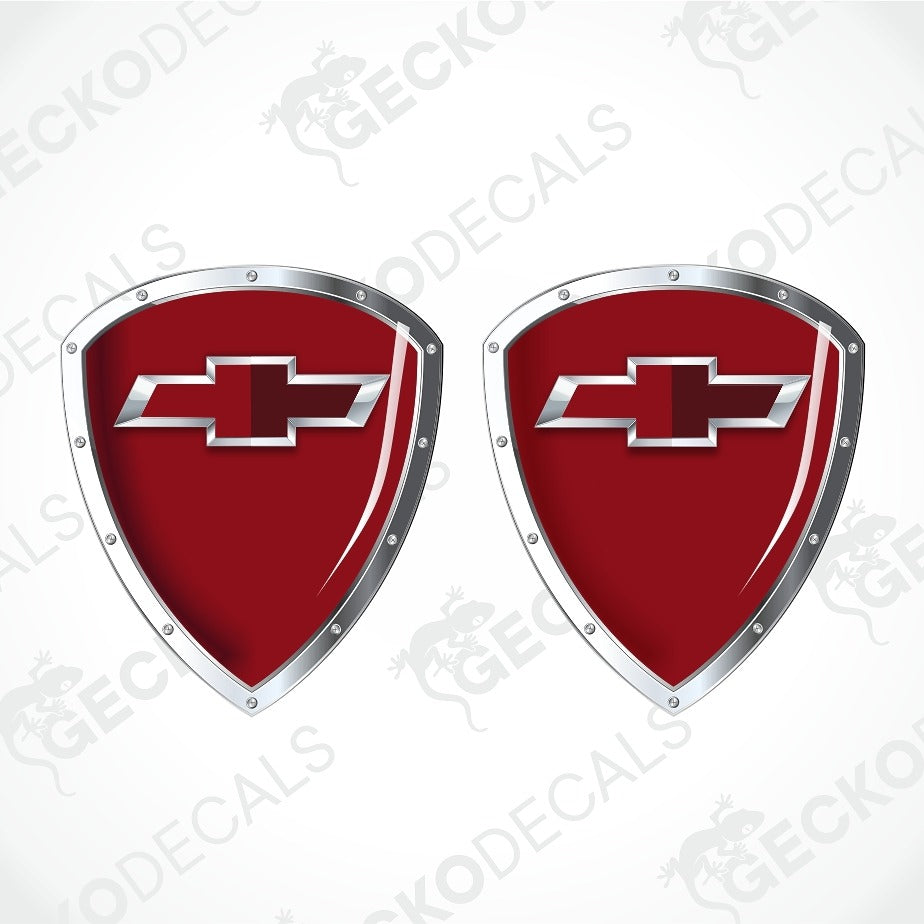 Two red shield-shaped decal emblems with silver metallic borders and Chevrolet bowtie logos, displayed on a white background with diagonal watermarks.