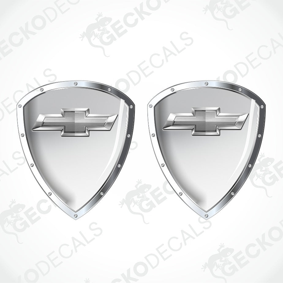 Two metallic silver shield-shaped decals with Chevrolet bowtie logos, shown on a light gray background with diagonal watermark text.