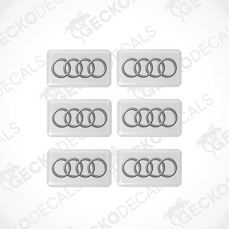 A set of six white and white vinyl decals with the Audi logo.