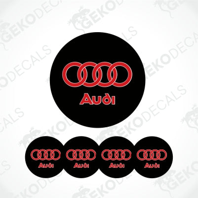 A set of four black vinyl decals with the Audi rings up and Audi letters down in red with white frame in center.
