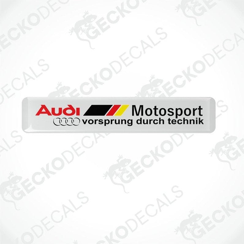 White vinyl stickers with red, black, and yellow Audi Motosport branding, placed on a white background.