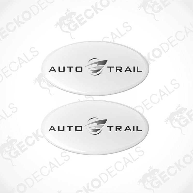 Two white oval-shaped epoxy decals with the AUTO-TRAIL brand logo in black.