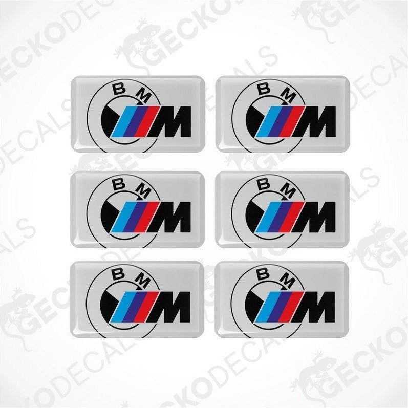 Set of six BMW M vinyl stickers with polyurethane coating featuring the M Performance logo in black, red and blue on a white background.