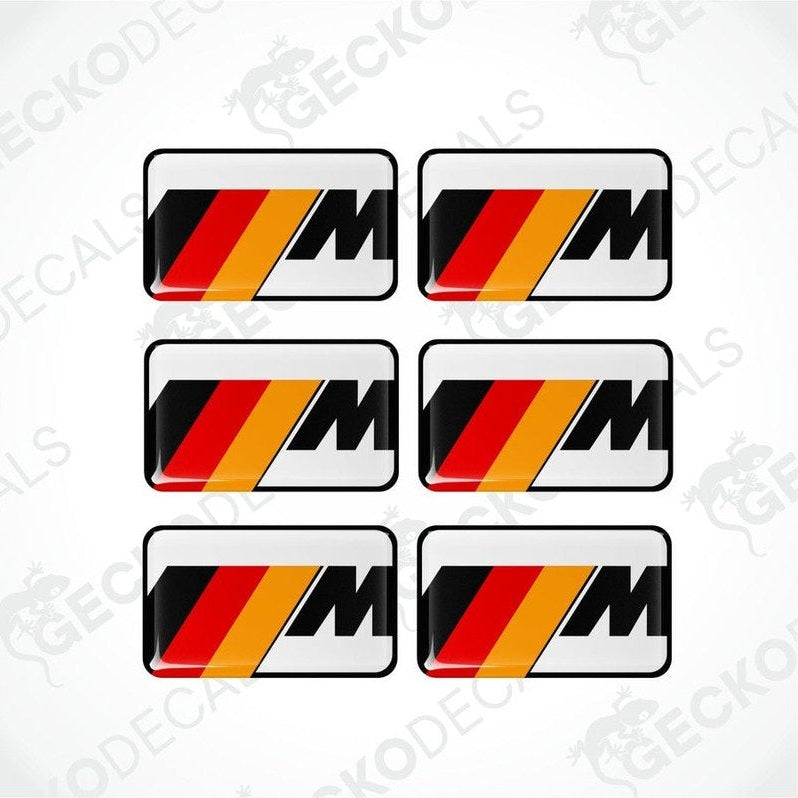 Set of six white BMW M branded polyurethane-coated vinyl stickers on a white background.