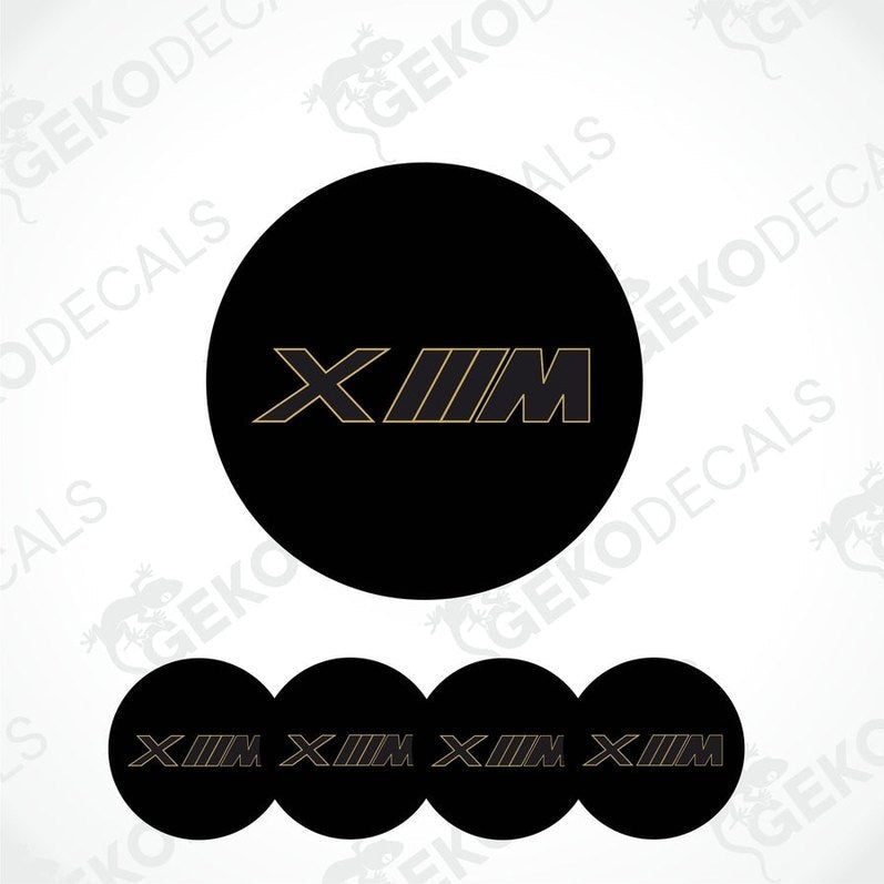 Set of four black vinyl decals with 'XM' logo in gold, intended for use on vehicle wheels.