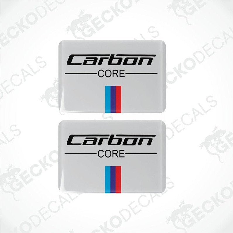 Two rectangular vinyl decals with 'Carbon CORE' text and a red and blue stripe on a white background.
