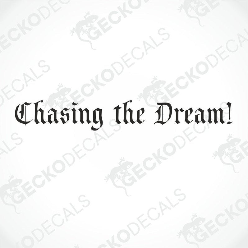 A decal with the phrase 'Chasing the Dream!' displayed on the front windscreen of a gray truck.