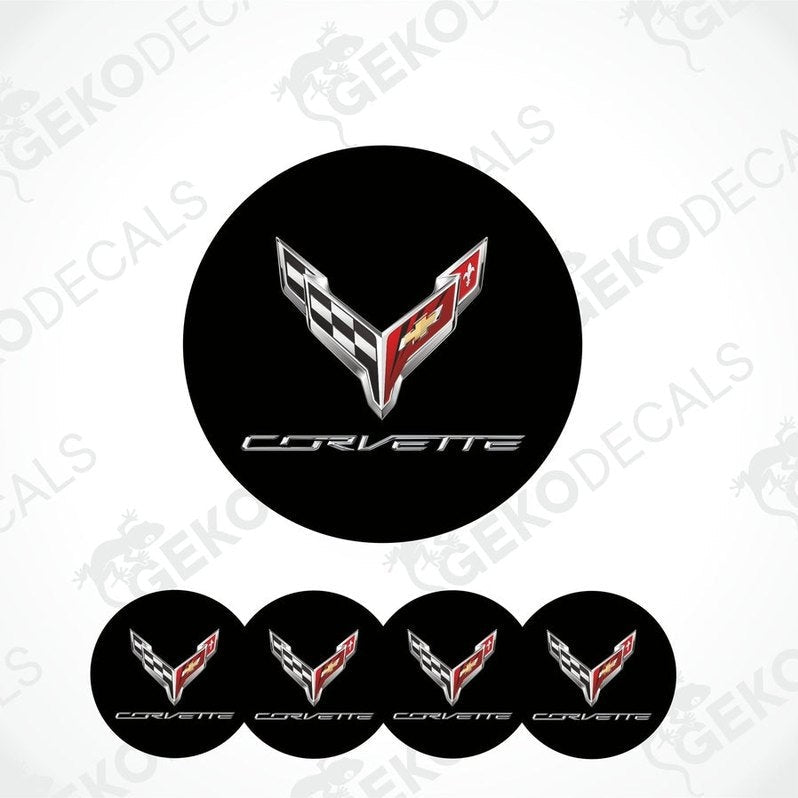 A set of four black vinyl stickers with the Chevrolet Corvette logo, including a design with red and white accents.