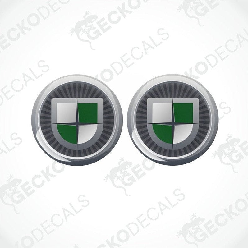 A set of two round vinyl decals with a geometric pattern and a green and silver color scheme, featuring the word 'GECKODECALS'.