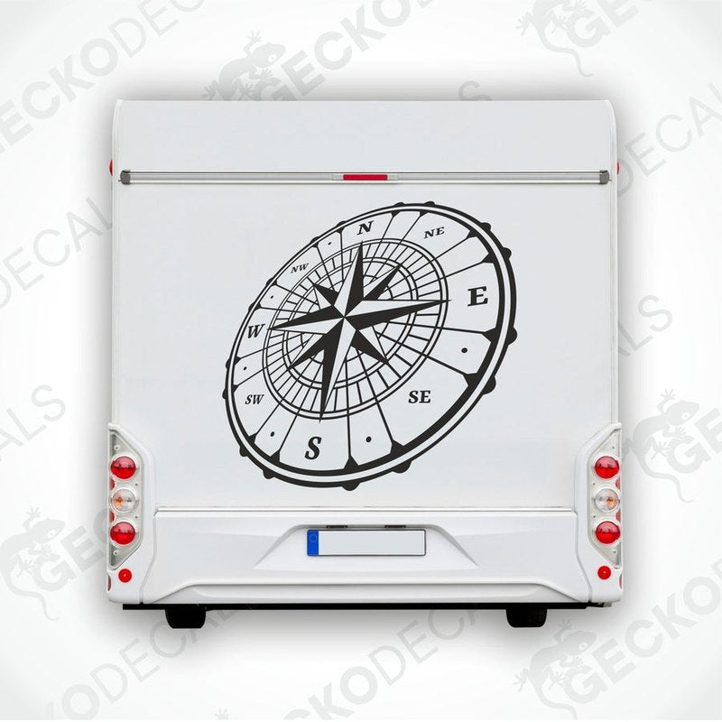 A white vehicle decal featuring a black compass design.