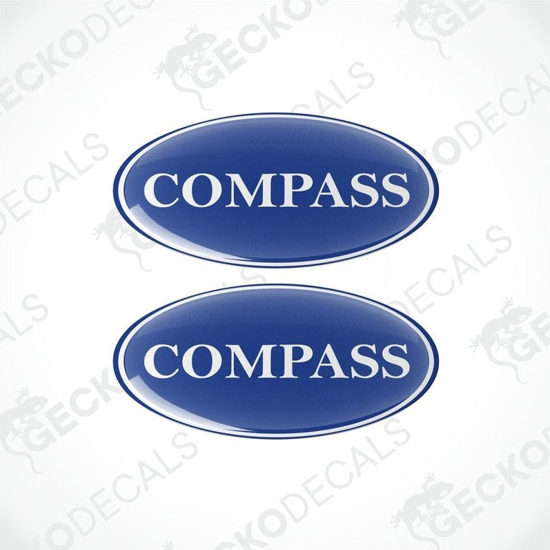 Two blue vinyl stickers with the word 'COMPASS' printed on them.