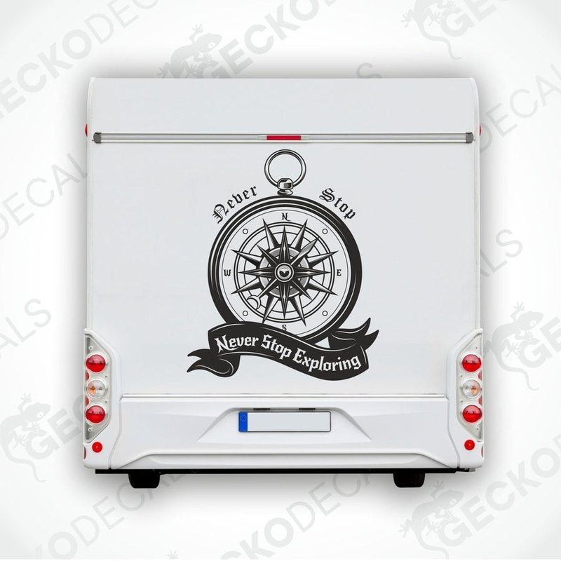 Black vintage compass decal on RV rear door with Never Stop Exploring text