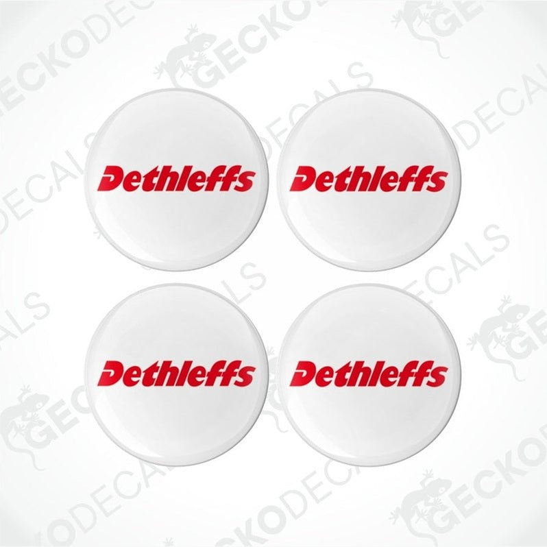 A set of four white, red, and black colored vinyl decals with the Dethleffs brand logo.