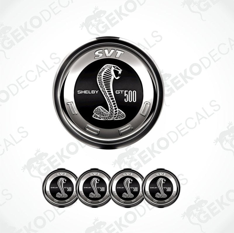 A set of four silver-colored vinyl stickers with a Shelby GT 500 logo, designed for use on car wheels or caps.