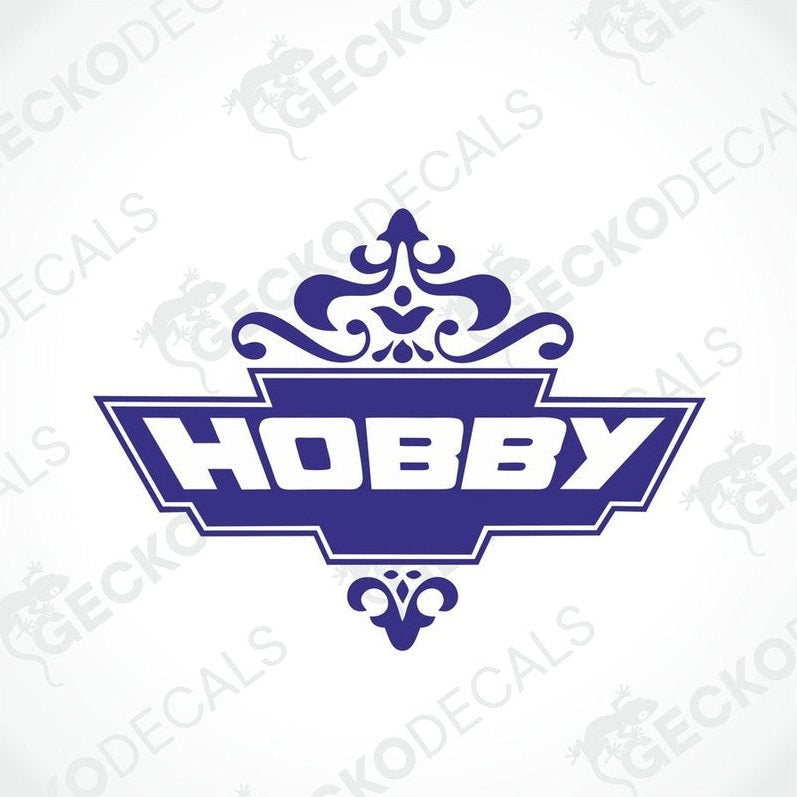 A die cut decal with the word 'HOBBY' in bold letters, surrounded by a decorative floral-like pattern, predominantly in blue color.