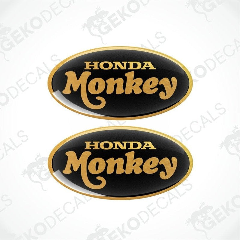Two Honda Monkey decals with gold text on a black background.
