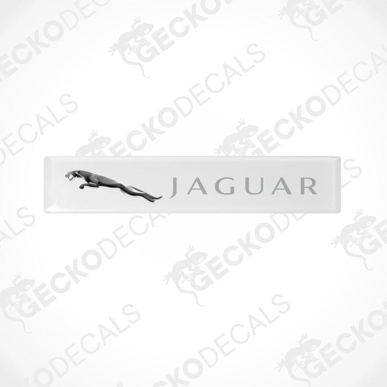 White rectangular car decals with the Jaguar brand logo and name written on them.