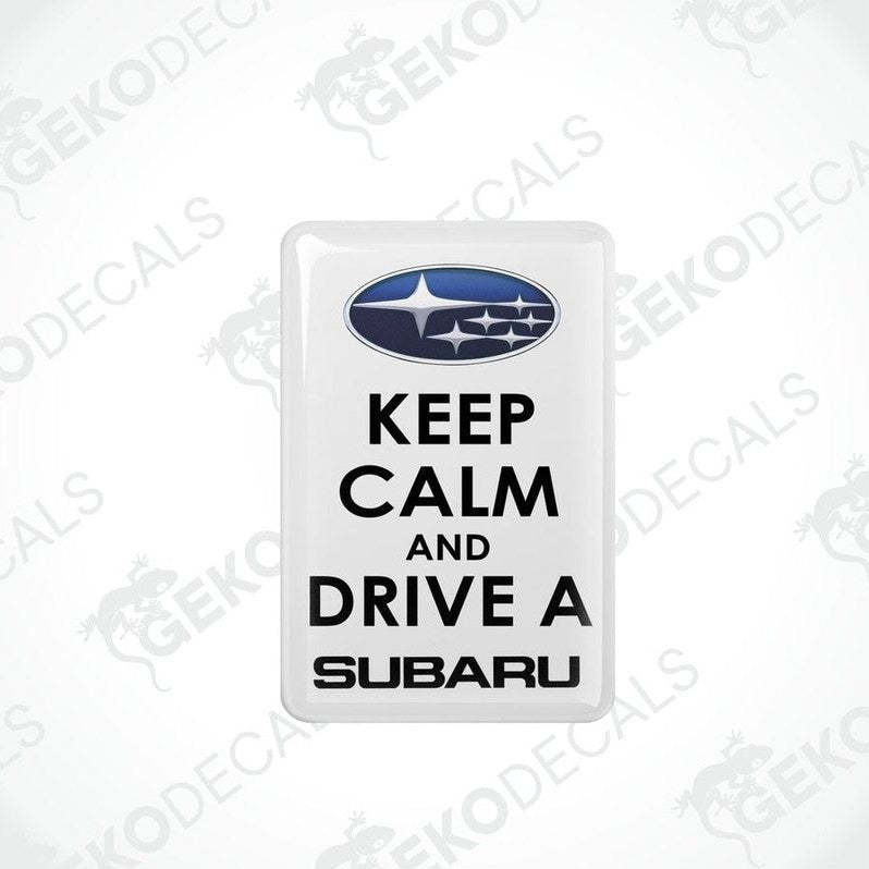 Withe vinyl stickers with the text 'KEEP CALM AND DRIVE A SUBARU' and the Subaru logo above the text.