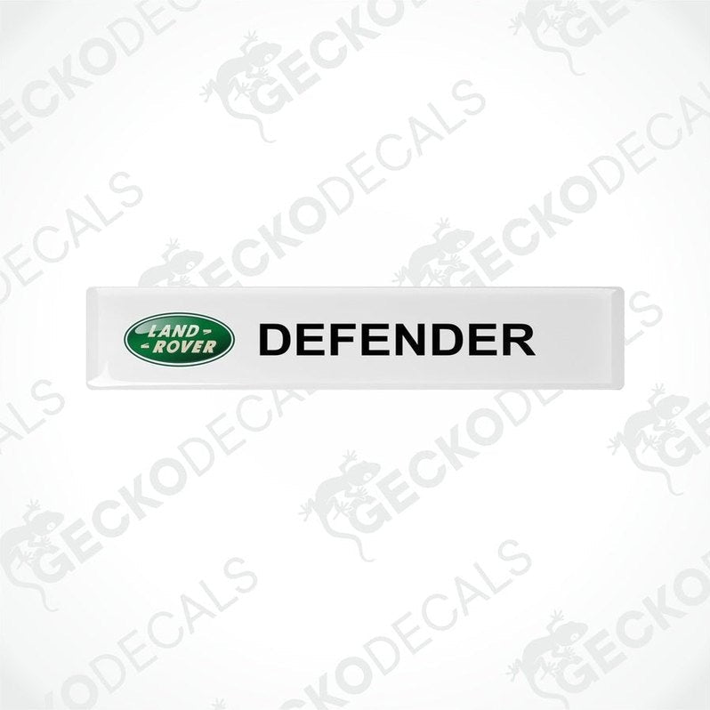 White vinyl decals with the text 'DEFENDER' and the Land Rover logo in green.