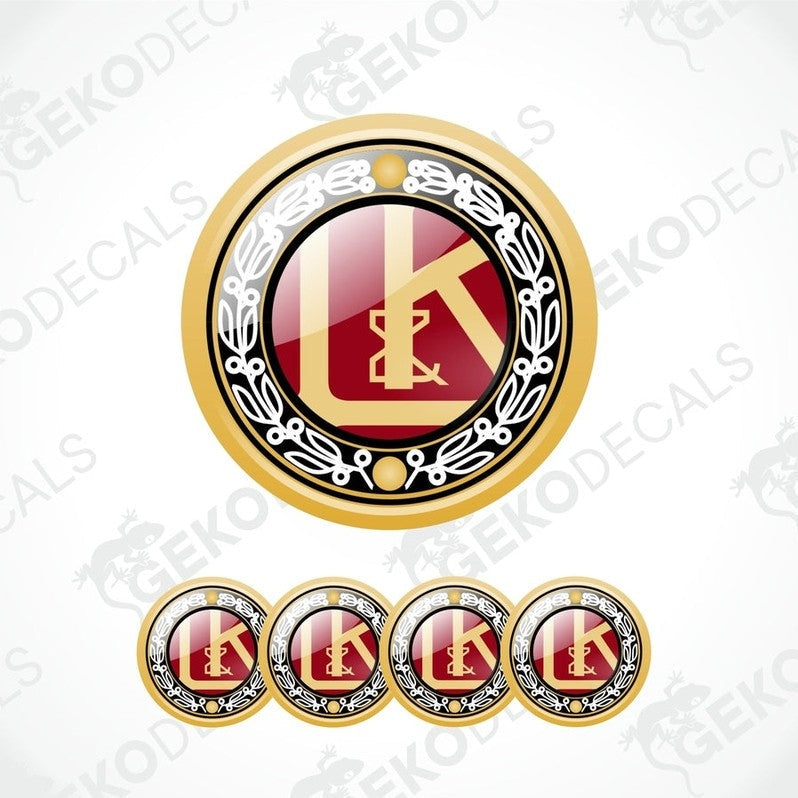 A set of four gold, red, and black vinyl stickers with a geometric design and the letter 'L' in the center, representing the brand LAURIN & KLEMENT.