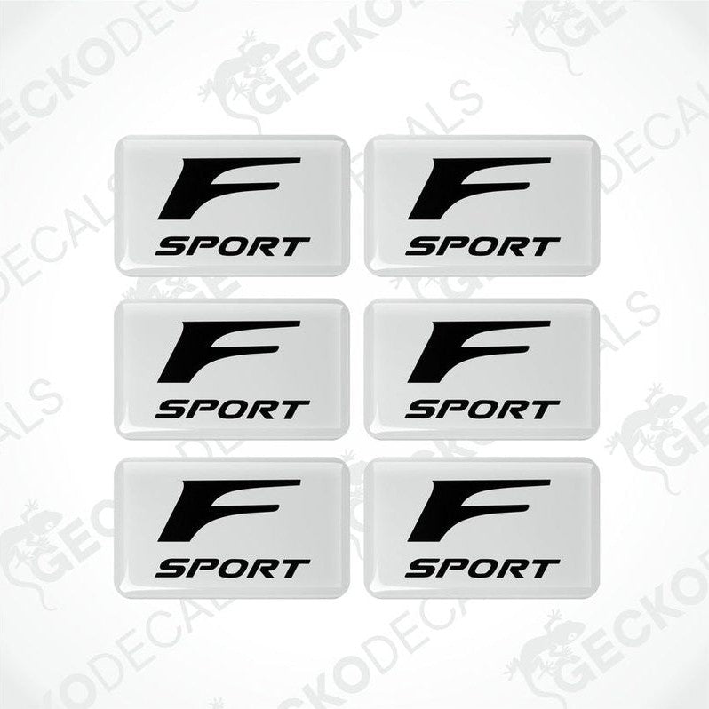 A set of six white vinyl stickers with the Lexus F Sport logo printed on them.