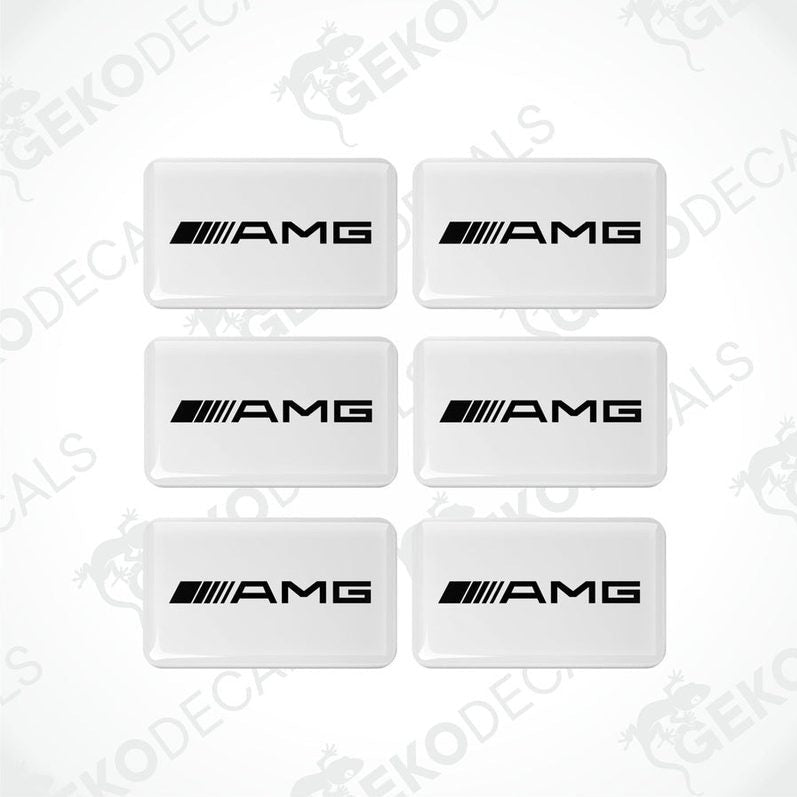 A set of six white rectangular car decals with the 'AMG' logo in black.