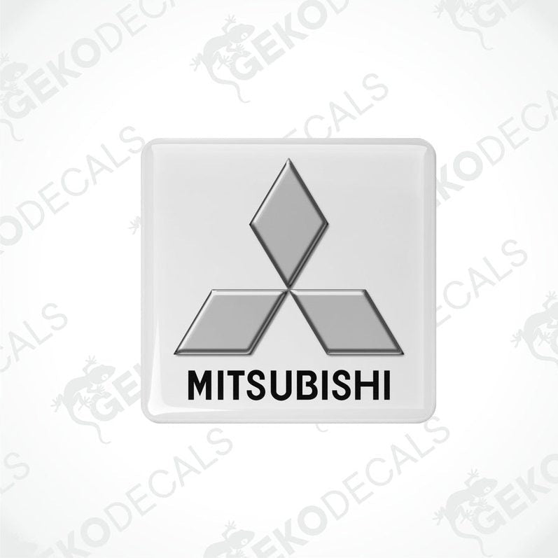 White vinyl stickers with a black Mitsubishi logo on each, placed against a white background.
