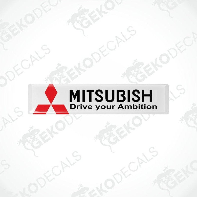 Rectangular white vinyl decals with the Mitsubishi logo and the text 'MITSUBISHI Drive your Ambition' in black and red.
