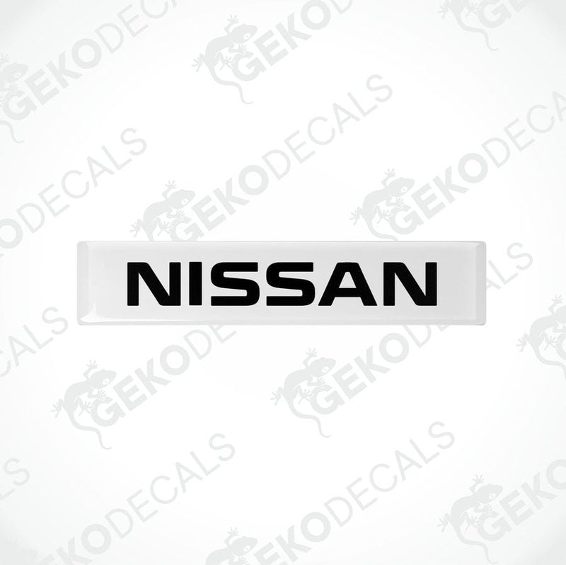 White rectangular car decals with the text 'NISSAN' in white uppercase letters