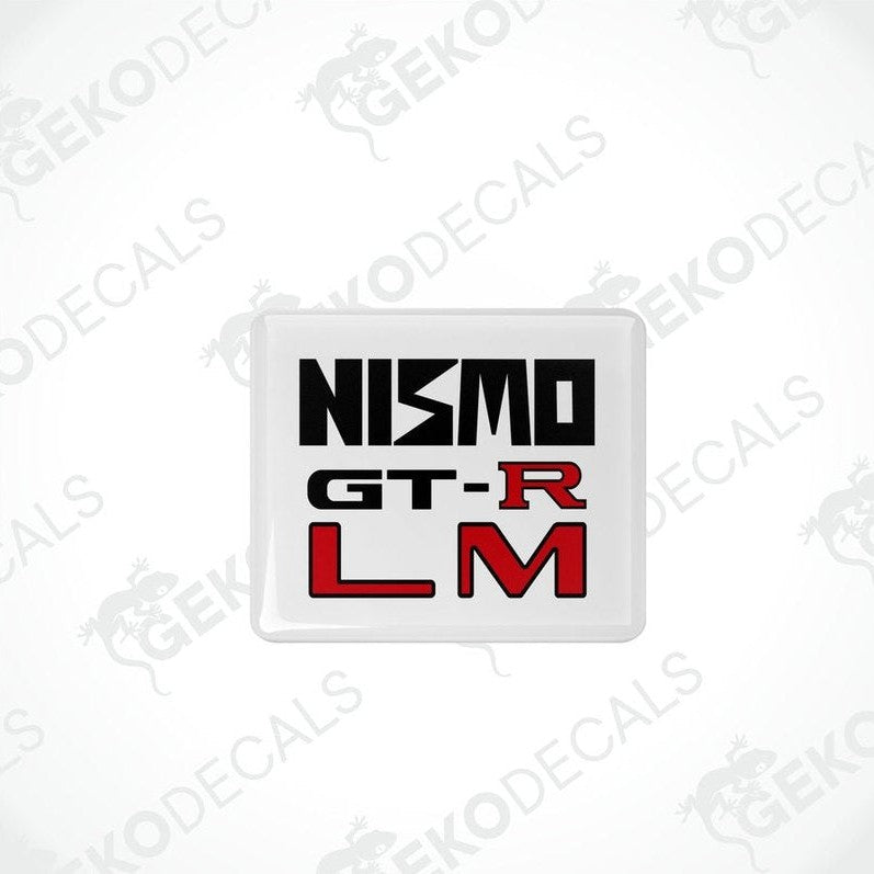 Square white vinyl decals with 'NISMO GT-R LM' written in black and red text.