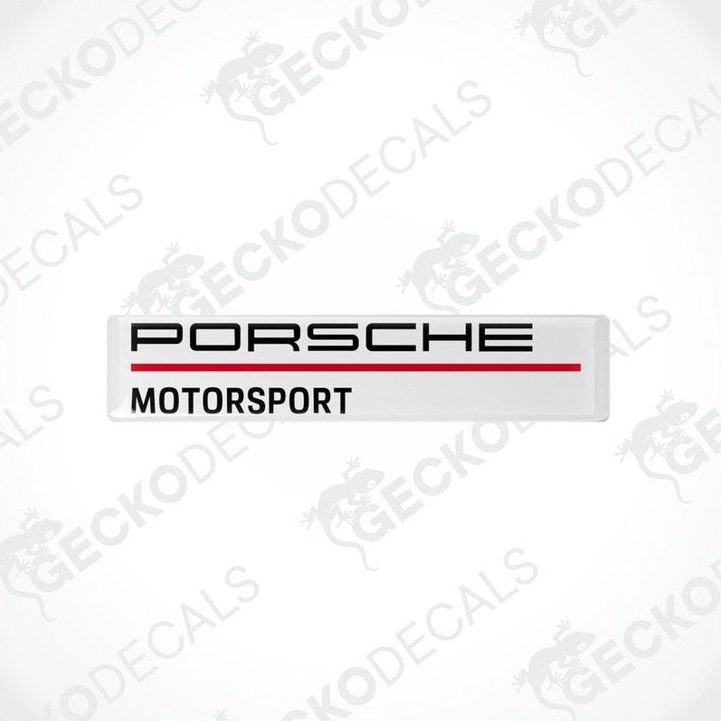 Rectangular withe vinyl decals with 'PORSCHE MOTORSPORT' text in black and red.