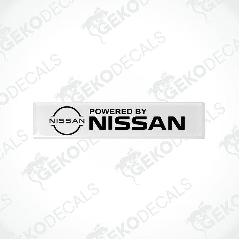 White vinyl stickers with 'Powered by NISSAN' text and a black circular logo of NISSAN in the center