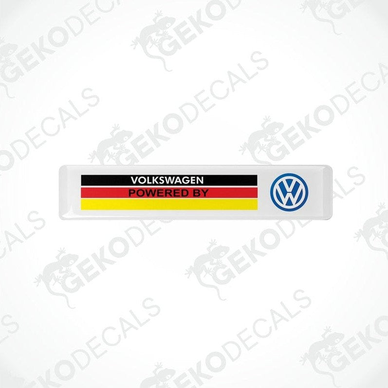 Withe vinyl stickers with the text 'Volkswagen POWERED BY' and a flag pattern in red and yellow and a blue logo on a white background.