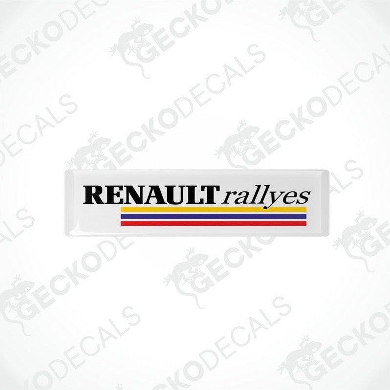 Withe vinyl stickers with the text 'RENAULT RALLYES' and the Renault logo in red, yellow, and blue.