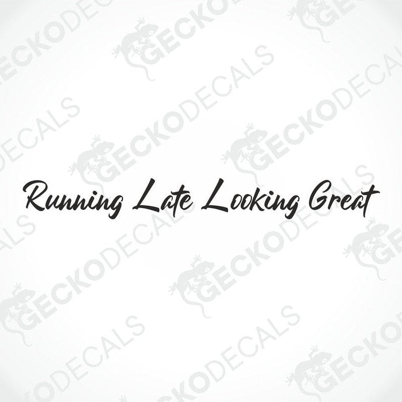 A decal with the text 'Running Late Looking Great' positioned on the front windshield of a gray truck.
