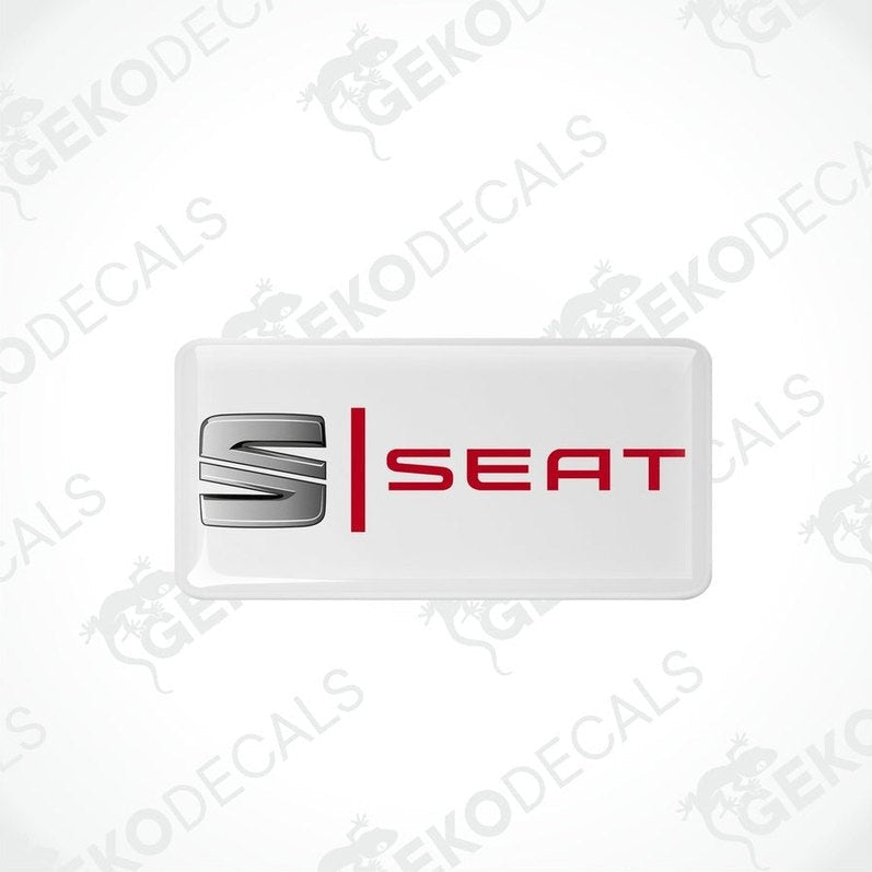 Withe vinyl stickers with the word 'SEAT' in red and silver.