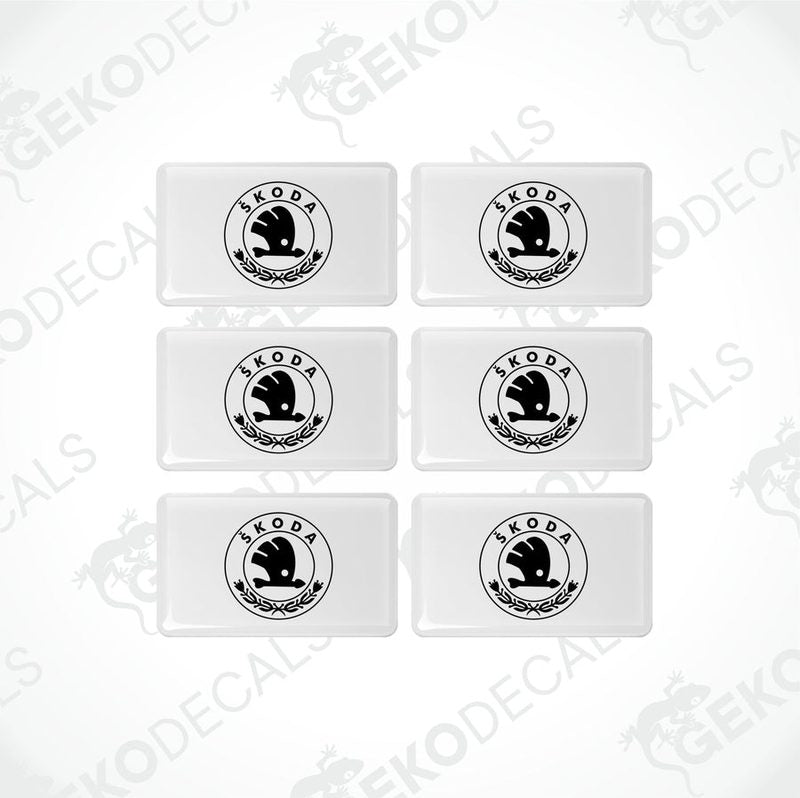 A set of six withe vinyl stickers with the Škoda Auto logo in black.