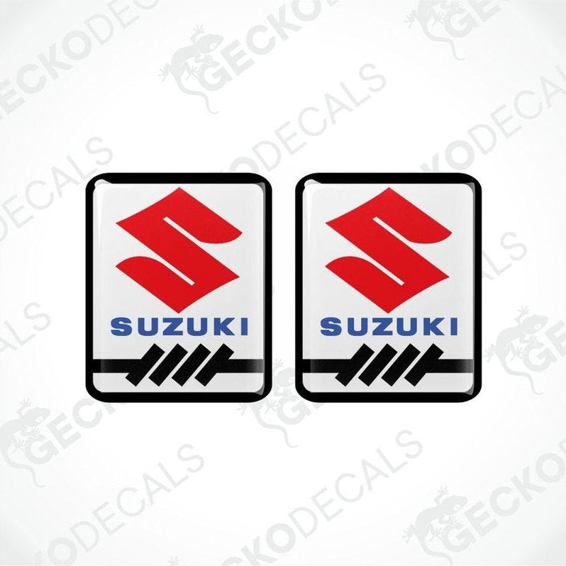 Two Suzuki logos with a red and black design on a white background.