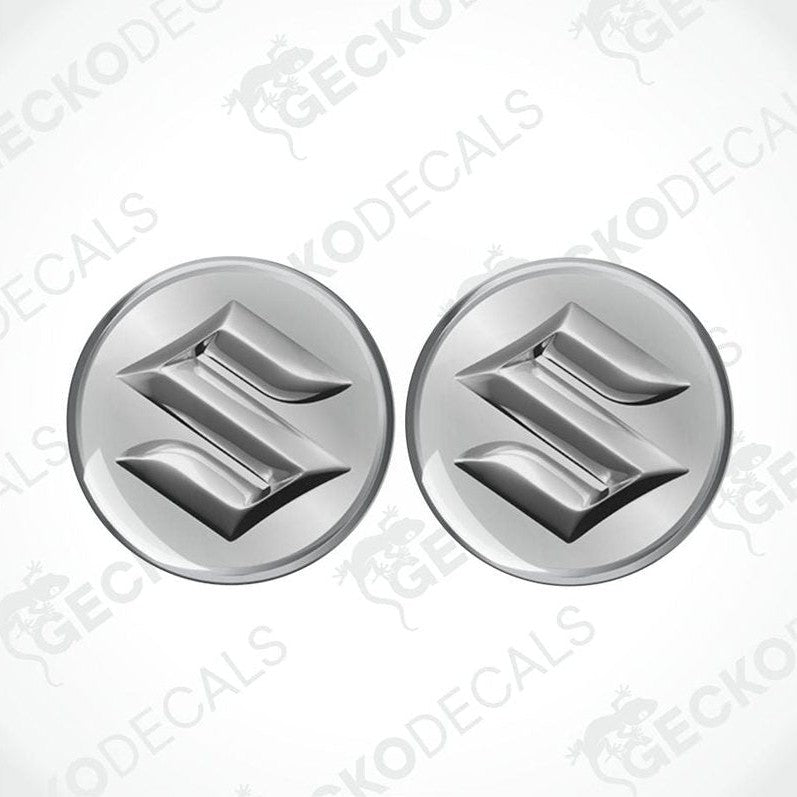 Two metallic Suzuki logos on a white background with 'Gecko Decals' branding.