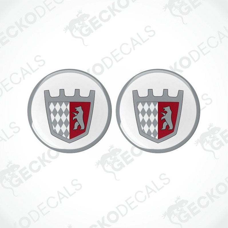 Two round vinyl stickers with a geometric pattern and a castle motif in red, white, and black colors on a transparent background.