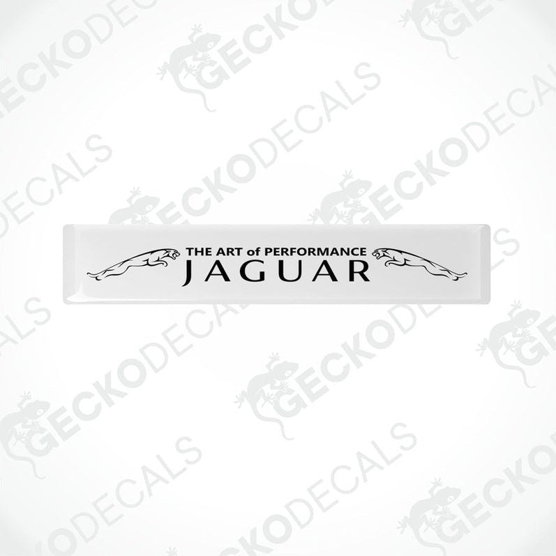 Rectangular white car decals with black text that reads 'THE ART OF PERFORMANCE JAGUAR'.