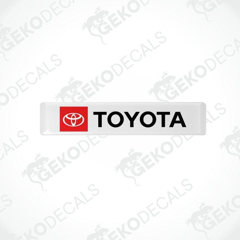 Withe vinyl stickers with the Toyota logo in red and black.