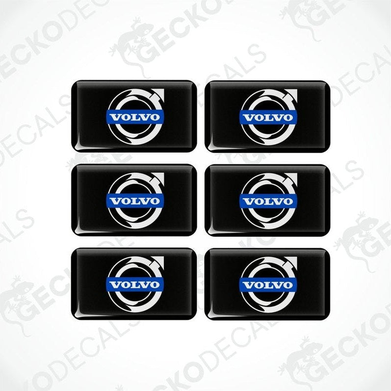 A set of six black vinyl stickers with the Volvo brand logo on them.