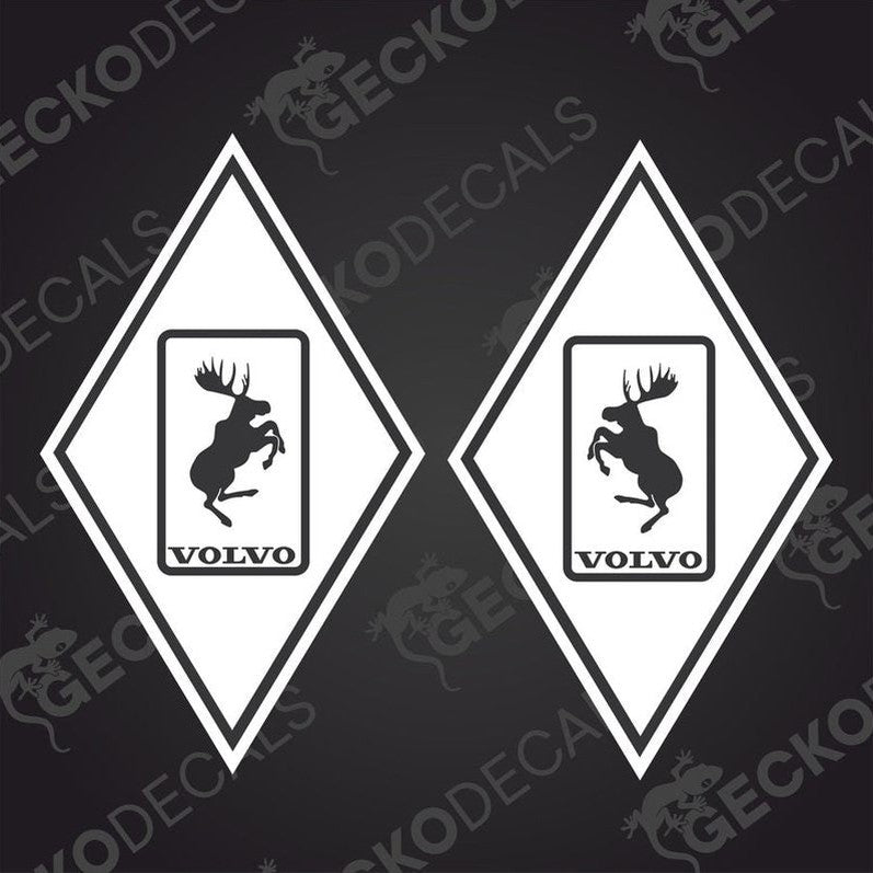 Two diamond-shaped vehicle decals, one with a moose design, the other featuring the Volvo brand logo, both in black, white, and gray colors.