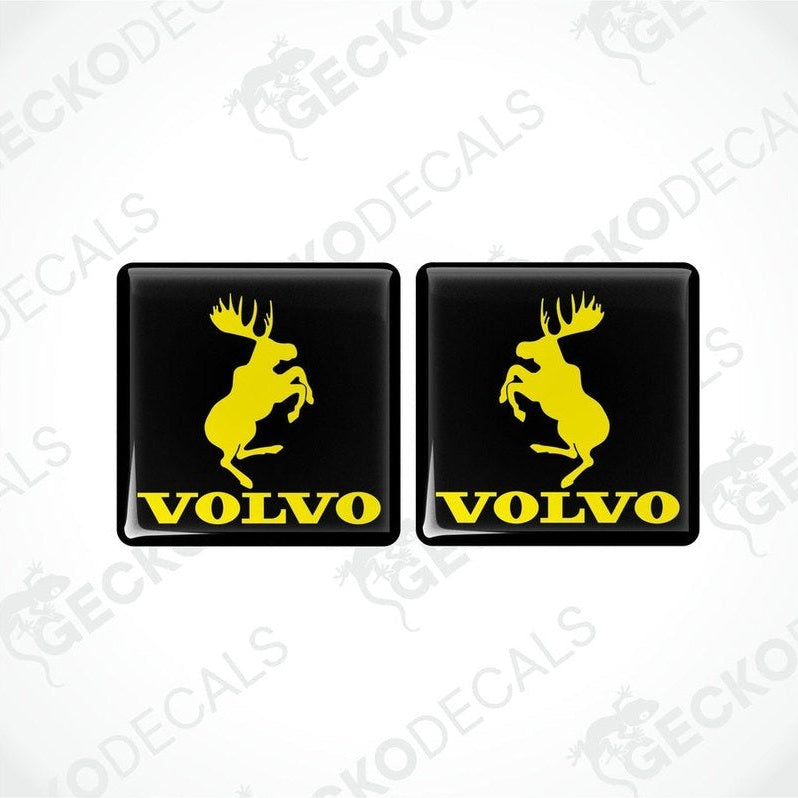 Two black square vinyl decals with the silhouette of a moose and the text 'VOLVO' below it.