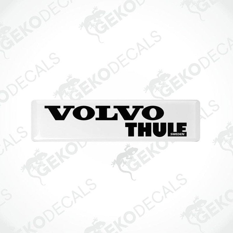 Two withe vinyl stickers with the word 'THULE' and the Volvo brand logo in black.